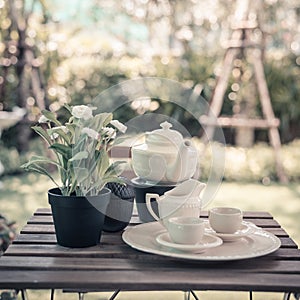 Cup of tea on wooden table in summer garden