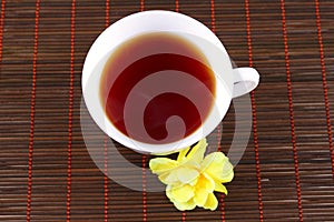 Cup of tea with a yellow flower
