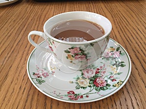 Black tea with milk in a classic Fine China cup