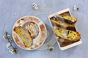 Cup of Trendy whipped cream dalgona coffee and Italian biscotti on light grey background