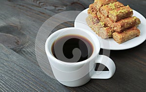 Cup of Turkish Coffee with Blurry Baklava Pastries in the Backdrop