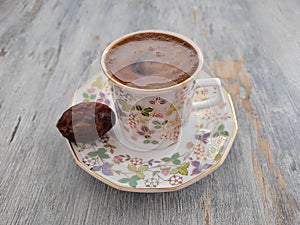 A cup of Turkish coffee with piece of date