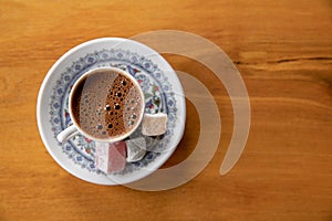 Cup of Turkish Coffee on a wooden table photo