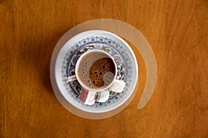 Cup of Turkish Coffee on a wooden table photo