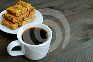 Cup of Turkish Coffee on Wooden Table with Pistachio Nuts Baklava Pastries