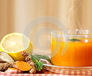 a cup of Turmeric Tea with lemon and ginger , Benefits for reduce Inflammation , Liver Detox and Cleanser healthy herb drink