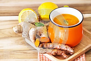 a cup of Turmeric Tea with lemon and ginger , Benefits for reduce Inflammation , Liver Detox and Cleanser healthy herb drink