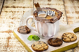 Cup of vegan hot chocolate, steaming and smoky hot drink, served at Christmas and New Year, with wholemeal cookies