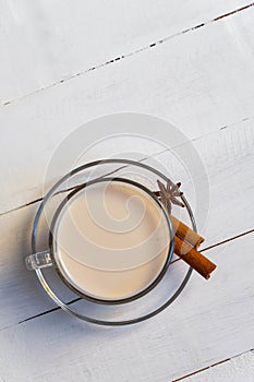 Cup of warm masala tea chai with star anise and cinnamon sticks