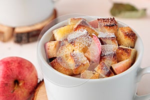 Cup of white bread pudding with apples