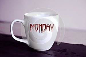 Cup with the word Monday written in bloody letters photo