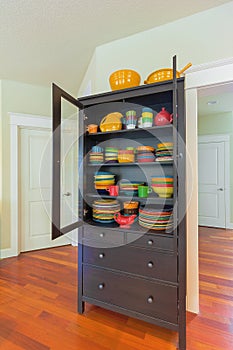 Cupboard with Colorful Dinnerware in Home