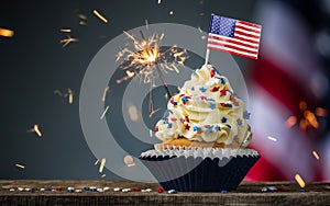 Cupcake and American Flag. Sparklers or fireworks lights burning in a cake. 4th of July, Independence, Presidents Day. Tasty cupca