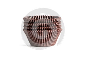 Cupcake baking cases pack isolated on white background. Brown greaseproof paper baking cups. Stack of cupcake liners