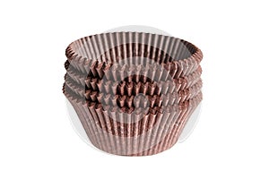 Cupcake baking cases pack isolated on white background. Brown greaseproof paper baking cups. Stack of cupcake liners