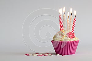 Cupcake with buning candles photo