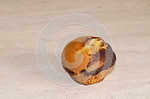 Cupcake with chocolate dousing on a wooden table