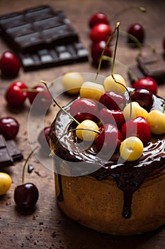 Cupcake with chocolate icing and cherries