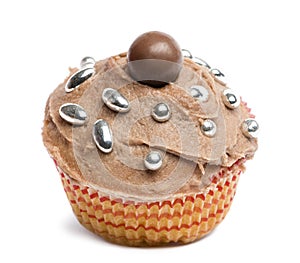 Cupcake with chocolate icing and decoration against white background