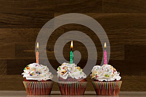 Cupcake. colorful cupcakes with sprinkled frosting and candles photo