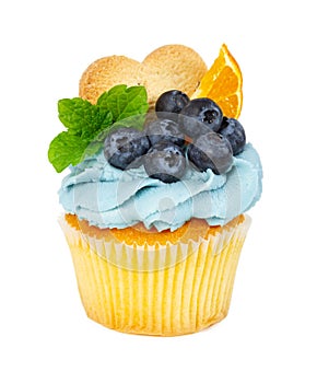 Cupcake with cookies, fresh blueberries, mint and slices of orange