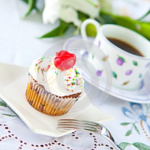 Cupcake with a cup of coffee