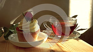 Cupcake decorated with cream and fresh raspberries