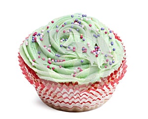 Cupcake with green icing and hundreds and thousands against white background