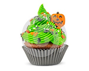 Cupcake on Halloween. Carved pumpkin. Jack o lantern. Dessert on Halloween party. Muffin decorated with colored sprinkles