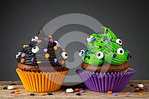 Cupcake on Halloween. Dessert on Halloween party. Chocolate muffin decorated with colored sprinkles