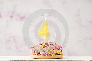 Cupcake with number four shaped candle for birthday
