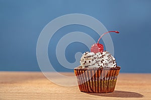 Cupcake with red cherry on top