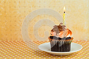 Cupcake on a Saucer with a Candle