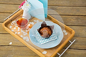 Cupcake, tea, flower vase and card in tray