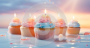 Cupcakes with buttercream frosting and burning candles on blue background