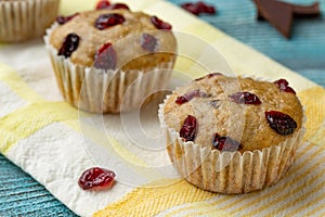 Cupcakes with cherries are located in a row.