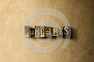 CUPCAKES - close-up of grungy vintage typeset word on metal backdrop