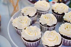 Cupcakes with cream for the festive table.