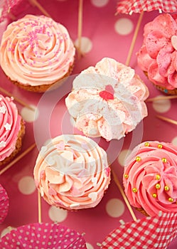 Cupcakes decorated with sprinkles and frosting