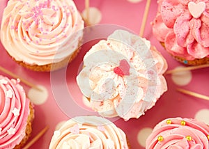 Cupcakes decorated with sprinkles and frosting