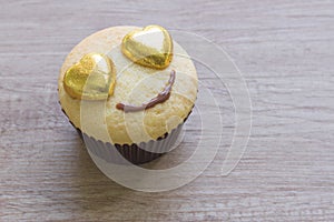 A cupcakes with heart shape chocolate on wooden table