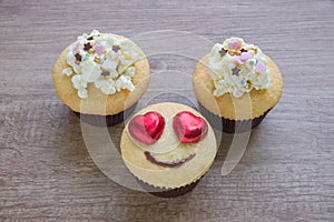 A cupcakes with heart shape chocolate on wooden table