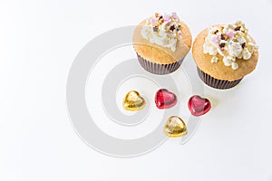 A cupcakes with heart shape chocolate on wooden table