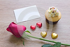 A cupcakes with heart shape chocolate on wooden table