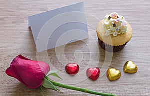 A cupcakes with heart shape chocolate on wooden table