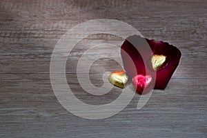 A cupcakes with heart shape chocolate on wooden table