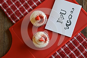 Cupcakes and loving sentiment on a wood background