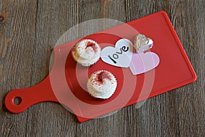 Cupcakes and loving sentiment on a wood background