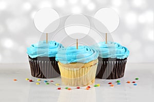 Cupcakes Mockup with Three Blue Frosted Cupcakes photo