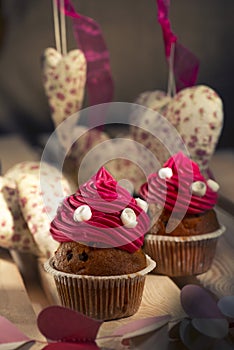 cupcakes with pink cream and white roses